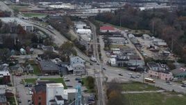 5.7K aerial stock footage passing a busy street and railroad tracks in industrial area in Lexington, Kentucky Aerial Stock Footage | DX0001_003223