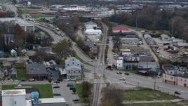 5.7K aerial stock footage reverse view of a busy street and railroad tracks in industrial area in Lexington, Kentucky Aerial Stock Footage | DX0001_003224
