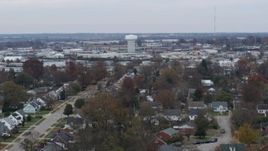 5.7K aerial stock footage descend toward homes with view of a water tower surrounded by warehouses in Lexington, Kentucky Aerial Stock Footage | DX0001_003238