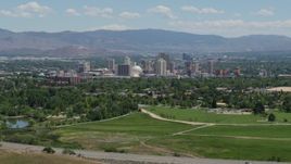 5.7K aerial stock footage of a view of the distant city skyline, seen from a park in Reno, Nevada Aerial Stock Footage | DX0001_004_007