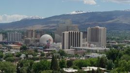5.7K aerial stock footage of hotels and casinos with mountains in the distance in Reno, Nevada Aerial Stock Footage | DX0001_004_009