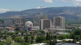 5.7K aerial stock footage of a view of hotels and casinos with mountains in the distance in Reno, Nevada Aerial Stock Footage | DX0001_004_010
