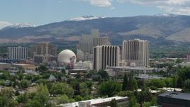 5.7K aerial stock footage of resort hotels and casinos with mountains in the distance in Reno, Nevada Aerial Stock Footage | DX0001_004_011