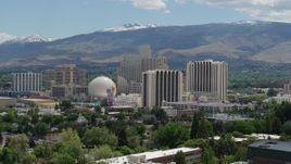 5.7K aerial stock footage of resort hotels and casinos with mountains in the distance in Reno, Nevada Aerial Stock Footage | DX0001_004_012