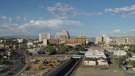 5.7K aerial stock footage of a reverse view of train tracks leading to casino resorts in Reno, Nevada Aerial Stock Footage | DX0001_005_002