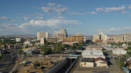 5.7K aerial stock footage of a reverse view of train tracks leading to the city skyline in Reno, Nevada Aerial Stock Footage | DX0001_005_004