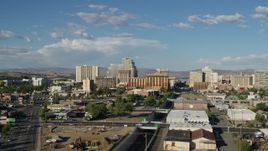 5.7K aerial stock footage of ascending over train tracks to fly toward the city skyline in Reno, Nevada Aerial Stock Footage | DX0001_005_005