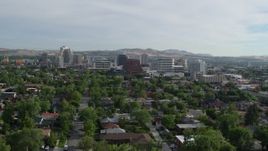 5.7K aerial stock footage of casino resorts and office buildings seen from neighborhood with trees in Reno, Nevada Aerial Stock Footage | DX0001_006_018