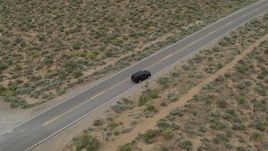 5.7K aerial stock footage approach a black SUV parked on a desert road in Carson City, Nevada Aerial Stock Footage | DX0001_007_020