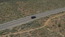 5.7K aerial stock footage track a black SUV driving on a desert road in Carson City, Nevada Aerial Stock Footage | DX0001_007_021