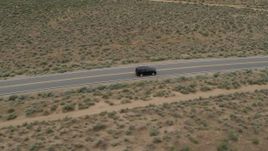 5.7K aerial stock footage track a black SUV as it drives on a desert road in Carson City, Nevada Aerial Stock Footage | DX0001_007_022