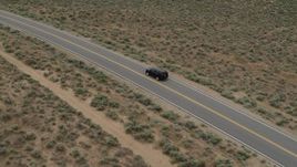 5.7K aerial stock footage track a black SUV as travels on a desert road in Carson City, Nevada Aerial Stock Footage | DX0001_007_024