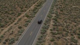 5.7K aerial stock footage of a black SUV pulling onto a desert road in Carson City, Nevada Aerial Stock Footage | DX0001_007_026