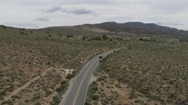 5.7K aerial stock footage of following a black SUV cruising on a desert road in Carson City, Nevada Aerial Stock Footage | DX0001_007_028