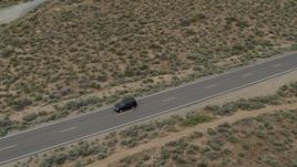 5.7K aerial stock footage of a black SUV driving on a desert road in Carson City, Nevada Aerial Stock Footage | DX0001_007_029