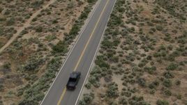 5.7K aerial stock footage of revealing a black truck driving on a desert road in Carson City, Nevada Aerial Stock Footage | DX0001_007_031