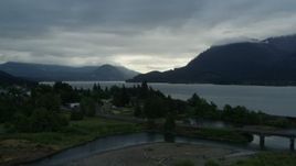 5.7K aerial stock footage of the Columbia River and cloud-shrouded mountains at sunrise, Stevenson, Washington Aerial Stock Footage | DX0001_008_001