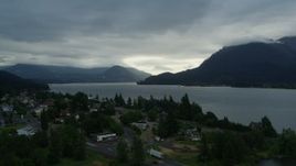 5.7K aerial stock footage approach the Columbia River and cloud-shrouded mountains at sunrise, Stevenson, Washington Aerial Stock Footage | DX0001_008_002