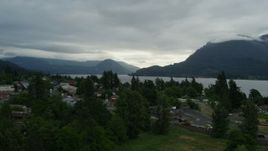 5.7K aerial stock footage of bridges spanning creek, and mountains across the Columbia River at sunrise, Stevenson, Washington Aerial Stock Footage | DX0001_008_004
