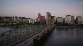 4K aerial stock footage of Hawthorne Bridge spanning the Willamette River at sunrise, Downtown Portland, Oregon Aerial Stock Footage | DX0001_010_001