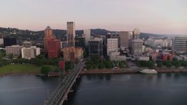 4K aerial stock footage of office buildings, Hawthorne Bridge spanning Willamette River at sunrise, Downtown Portland, Oregon Aerial Stock Footage | DX0001_010_002