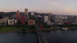 4K aerial stock footage flying by downtown, over the Hawthorne Bridge at sunrise, Downtown Portland, Oregon Aerial Stock Footage | DX0001_010_005