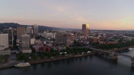 4K aerial stock footage of downtown buildings, Morrison Bridge at sunrise, Downtown Portland, Oregon Aerial Stock Footage | DX0001_010_008
