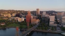 4K aerial stock footage flying away from downtown, over the Hawthorne Bridge at sunrise, Downtown Portland, Oregon Aerial Stock Footage | DX0001_010_013