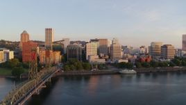 4K aerial stock footage descending near Hawthorne Bridge at sunrise with views of Downtown Portland, Oregon Aerial Stock Footage | DX0001_010_018