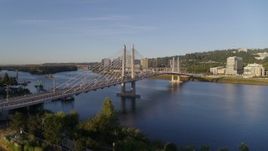 4K aerial stock footage ascend to approach the Tilikum Crossing, Bridge of the People, spanning Willamette River, South Portland, Oregon Aerial Stock Footage | DX0001_010_026