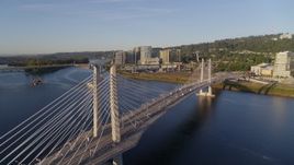 4K aerial stock footage flying by Tilikum Crossing, Bridge of the People, spanning Willamette River, South Portland, Oregon Aerial Stock Footage | DX0001_010_028
