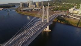 4K aerial stock footage orbiting Tilikum Crossing, Bridge of the People, revealing shoreline, South Portland, Oregon Aerial Stock Footage | DX0001_010_031