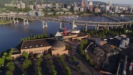 5.7K aerial stock footage approaching OMSI, with Marquam Bridge and downtown in the background, Southeast Portland, Oregon Aerial Stock Footage | DX0001_010_047