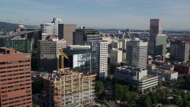 5.7K aerial stock footage approaching skyscrapers and an office building under construction, Downtown Portland, Oregon Aerial Stock Footage | DX0001_011_006