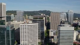 5.7K aerial stock footage flying closely by downtown skyscrapers and office buildings, partly cloudy, Downtown Portland, Oregon Aerial Stock Footage | DX0001_011_015