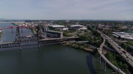 5.7K aerial stock footage of the Steel Bridge spanning the Willamette River near Moda Center arena, Northeast Portland, Oregon Aerial Stock Footage | DX0001_012_005