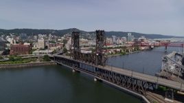 5.7K aerial stock footage orbit of the Steel Bridge spanning Willamette River, Downtown Portland, Oregon Aerial Stock Footage | DX0001_012_014
