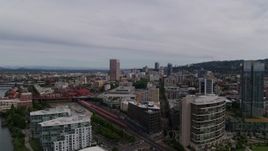 5.7K aerial stock footage of distant skyscrapers seen from the train station and condominiums, Downtown Portland, Oregon Aerial Stock Footage | DX0001_013_001
