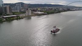 5.7K aerial stock footage tracking a tugboat and revealing Fremont Bridge, Downtown Portland, Oregon Aerial Stock Footage | DX0001_013_007