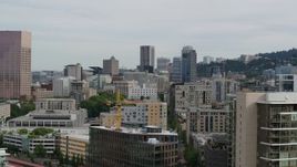 5.7K aerial stock footage reverse from Downtown Portland skyscrapers at sunset and descend by condos, Oregon Aerial Stock Footage | DX0001_013_016