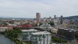 5.7K aerial stock footage of panning across Broadway Bridge and condominiums at sunset to reveal Downtown Portland, Oregon Aerial Stock Footage | DX0001_013_022
