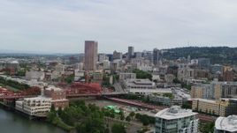 5.7K aerial stock footage of a reverse view of Downtown Portland, Oregon at sunset, revealing condominiums Aerial Stock Footage | DX0001_013_024