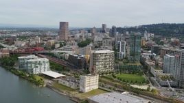 5.7K aerial stock footage of downtown buildings, waterfront condominiums and a park, sunset, Downtown Portland, Oregon Aerial Stock Footage | DX0001_013_025