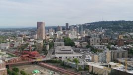 5.7K aerial stock footage flying over condominiums toward downtown skyscrapers, sunset, Downtown Portland, Oregon Aerial Stock Footage | DX0001_013_027