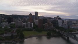 5.7K aerial stock footage approaching the KOIN Center and Marriott Hotel from the Willamette River, sunset, Downtown Portland, Oregon Aerial Stock Footage | DX0001_014_015