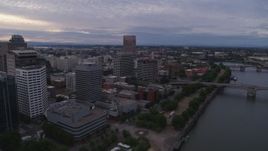 5.7K aerial stock footage flying away from the Morrison Bridge with Downtown Portland office buildings to the west, twilight, Oregon Aerial Stock Footage | DX0001_014_017