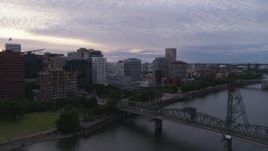 5.7K aerial stock footage of Hawthorne Bridge and office buildings along the water, twilight, Downtown Portland, Oregon Aerial Stock Footage | DX0001_014_025