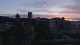 5.7K aerial stock footage flying by a bridge with a view of Downtown Portland, Oregon at twilight Aerial Stock Footage | DX0001_014_033