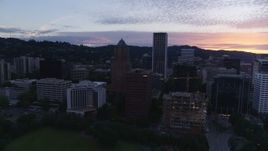 5.7K aerial stock footage pulling back from office buildings and skyscrapers in Downtown Portland, Oregon, twilight Aerial Stock Footage | DX0001_014_036