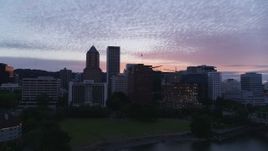 5.7K aerial stock footage flying across the river toward the Downtown Portland, Oregon skyline at twilight Aerial Stock Footage | DX0001_014_038